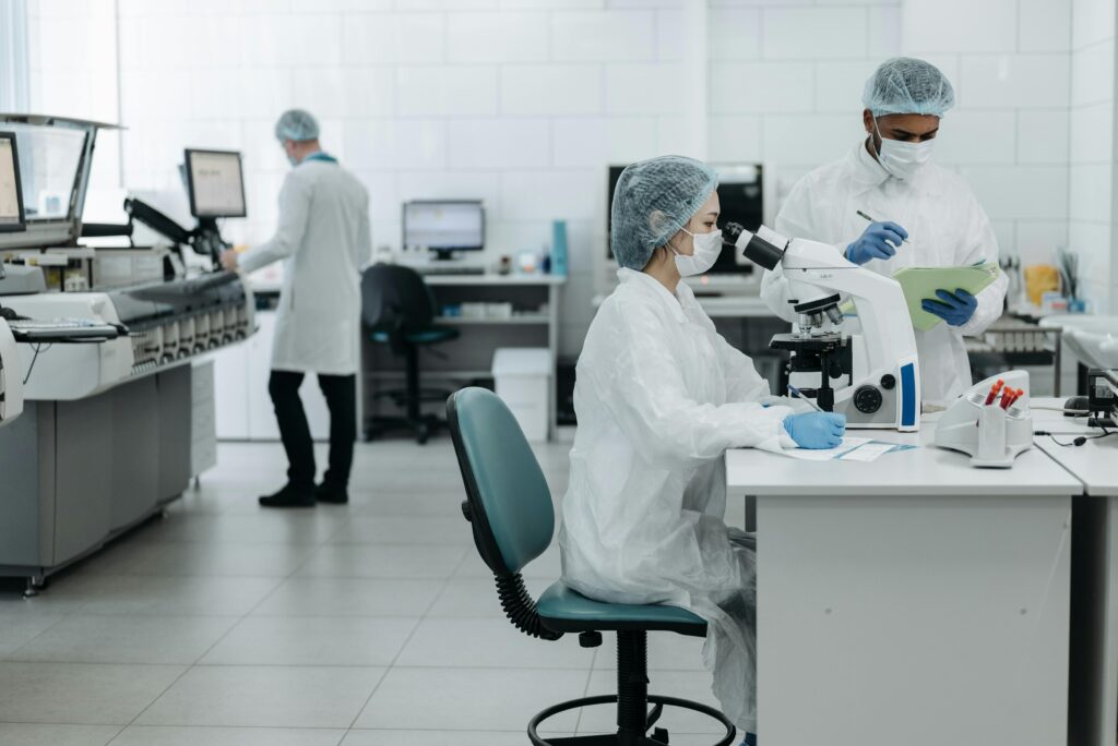 국가R&D 참여제한 2년 처분 승소사례 Researchers in protective gear examining samples in a state-of-the-art laboratory setting.
